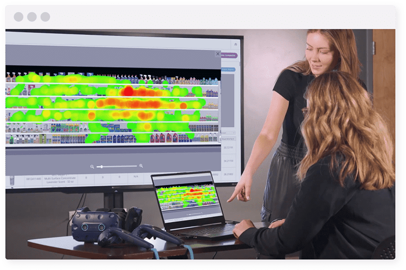 Two female executives looking at cleaning aisle heatmap on laptop and TV screen from VR research