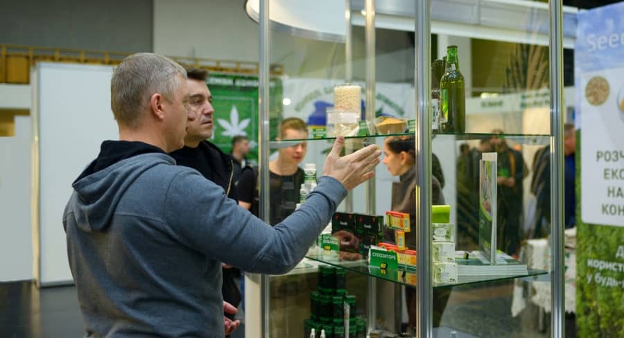 Men looking at cannabis products in a case