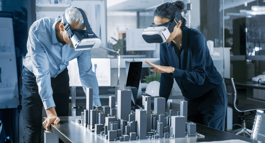 Two executives with VR headsets looking at a 3D virtual city scape on the table