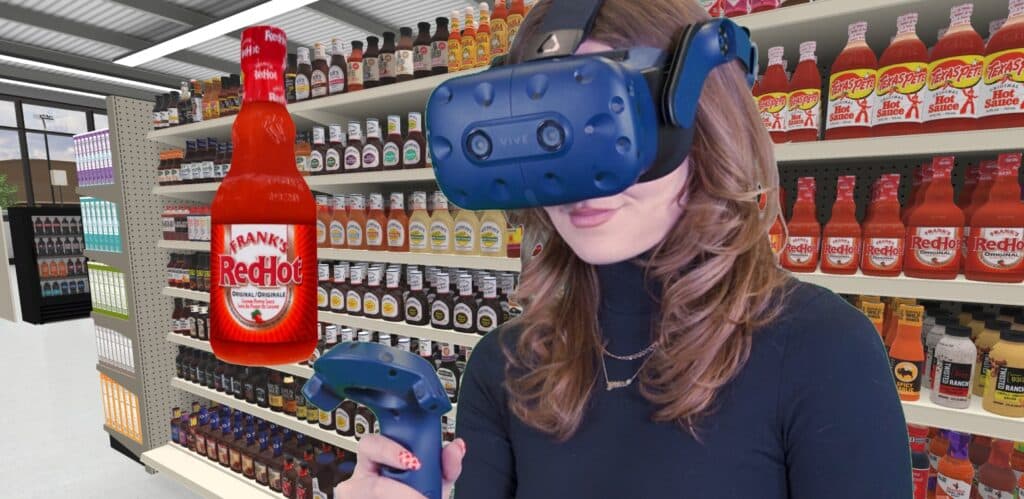 Woman in VR headset looking at 3D model of Frank's RedHot in grocery store condiment and sauce aisle